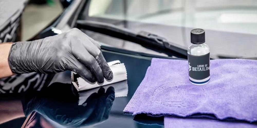 Professional ceramic coating application on prepared vehicle paint
